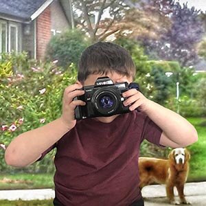 child looking thru an camera taking a picture